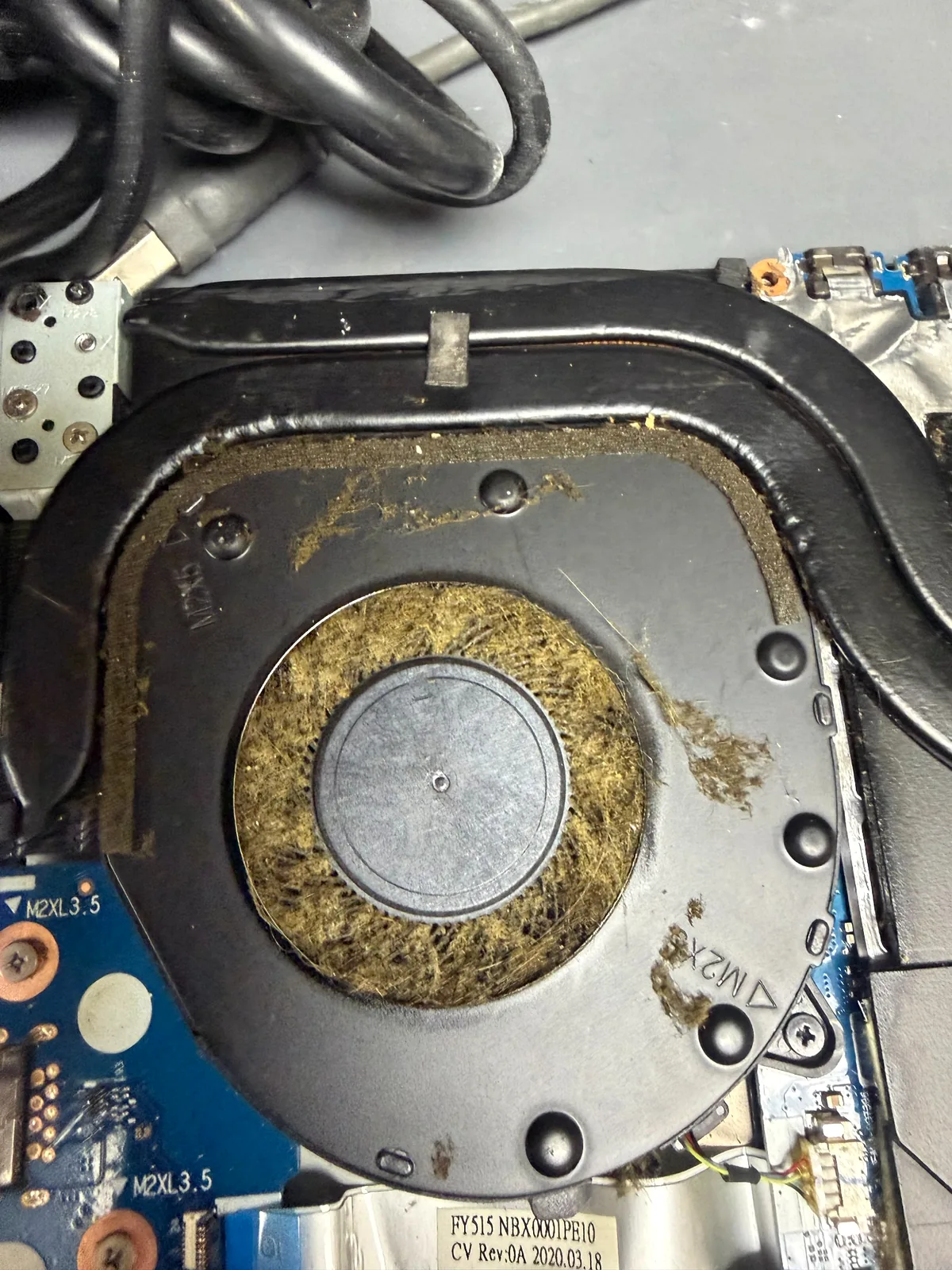 Dust clogged laptop cooling fan before cleaning